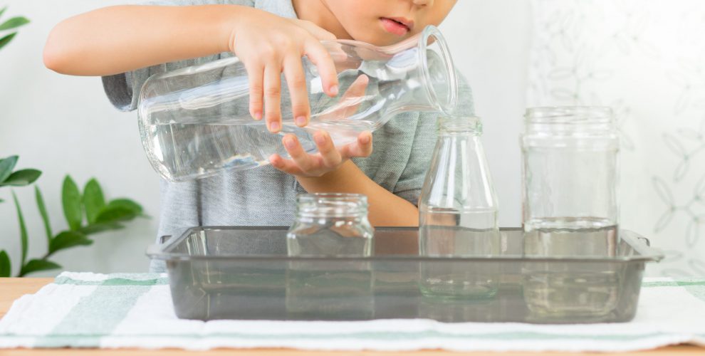Adorable,Little,Kindergarten,Child,,Boy,Pours,Water,From,Glass,Jar
